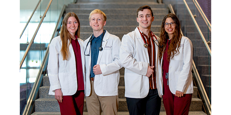 White coats and wedding rings photo of engaged students